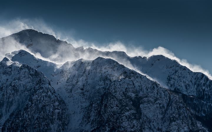 clouds over snow mountain range cliff MacBook Air wallpaper