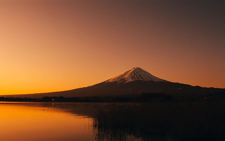 silhouette photography of mountain near lake durin MacBook Air wallpaper