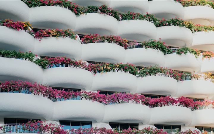 white building with balconies and plants All Mac wallpaper