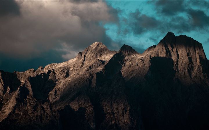 a rocky mountain with clouds 5k MacBook Pro wallpaper