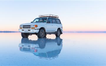white SUV parked on body of water All Mac wallpaper