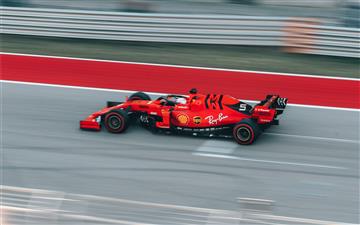 selective focus photography of red Formula 1 on tr MacBook Pro wallpaper