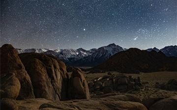 brown rocky mountain under blue sky during night t All Mac wallpaper