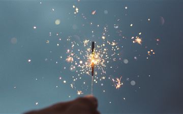 person holding lighted sparklers All Mac wallpaper