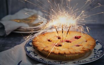 brown pie with sparklers on top All Mac wallpaper