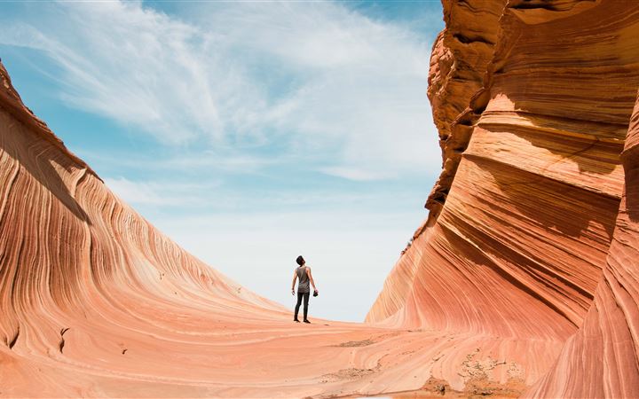 man on antelope canyon during daytime iMac wallpaper