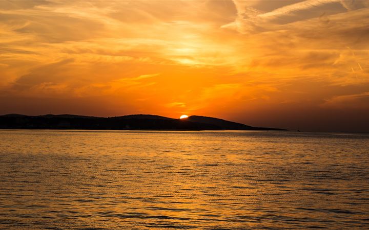 sunset island mountains sea iMac wallpaper