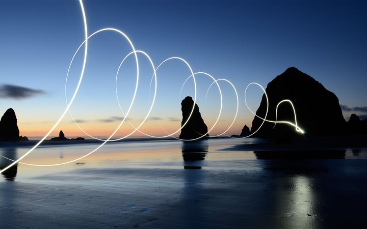 Light painting spirals over the water All Mac wallpaper
