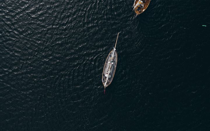 aerial view of white boat on body of water during All Mac wallpaper