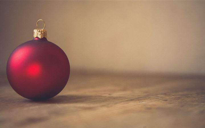 closeup photo of red ball ornament on surface All Mac wallpaper