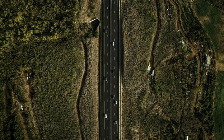 eagle eye photography of road surrounded by green All Mac wallpaper