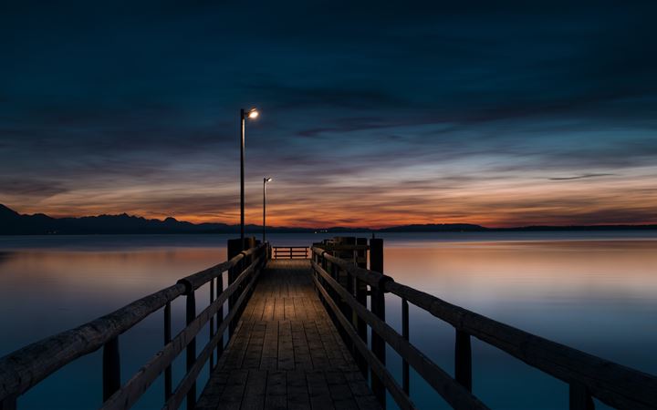 lamp post turned on at brown wooden dock All Mac wallpaper