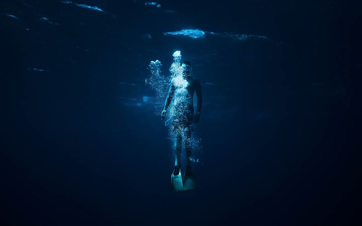 person diving on body of water All Mac wallpaper