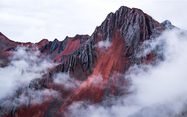 red mountain peeking out behind the clouds cusco p MacBook Air wallpaper