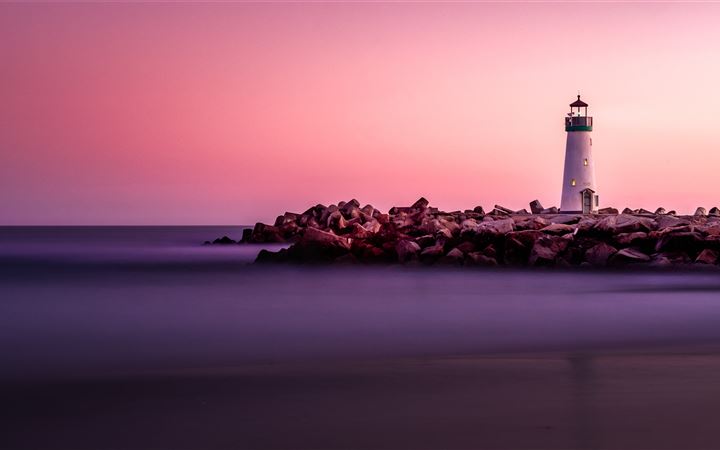 white lighthouse on rocky seashore MacBook Air wallpaper