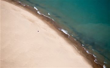 Drone view of sand shorel... iMac wallpaper