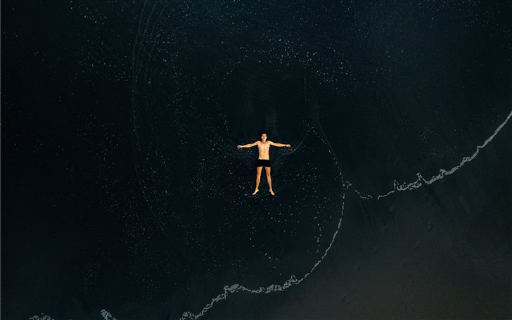 man lying on water Mac Wallpaper