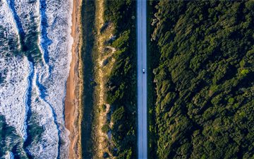 aerial photography of concrete road between trees All Mac wallpaper