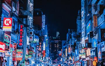 people between city buildings at night MacBook Air wallpaper