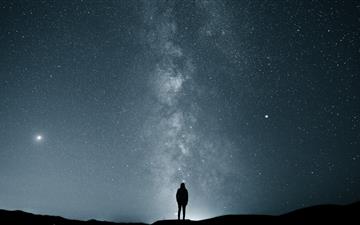silhouette of person under starry sky MacBook Pro wallpaper