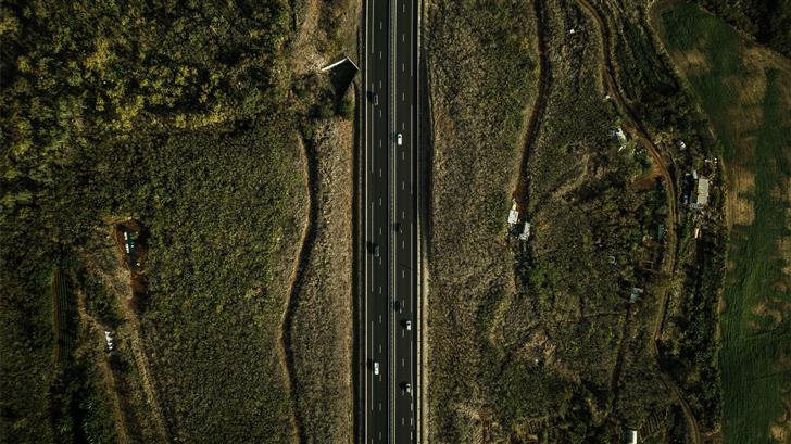 eagle eye photography of road surrounded by green  Mac Wallpaper