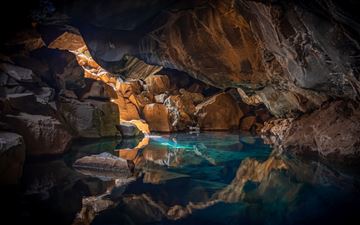 iceland cave surrouned with blue body of water 5k All Mac wallpaper