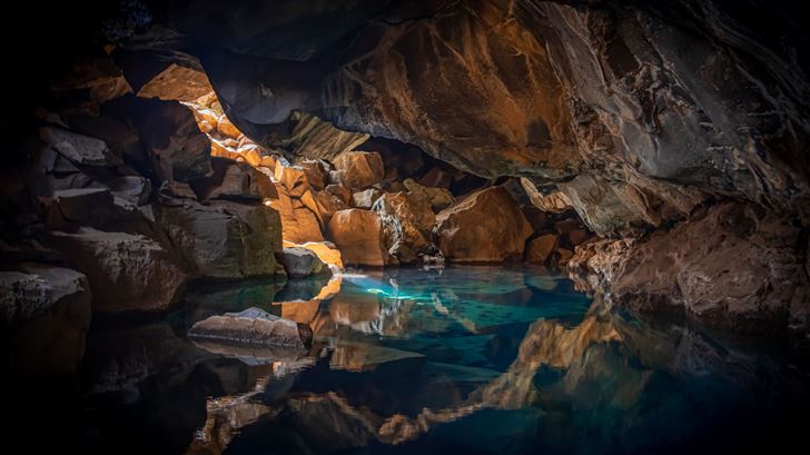 iceland cave surrouned with blue body of water 5k Mac Wallpaper