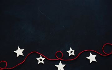 white stars cutout on black surface with red strin All Mac wallpaper