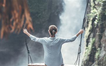 woman swings near waterfall 5k All Mac wallpaper