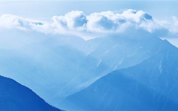 silhouette of mountains under cloudy sky 5k All Mac wallpaper