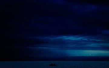 dark evening blue cloudy alone boat in ocean 5k All Mac wallpaper