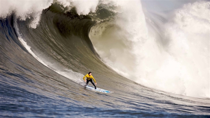 A Surfer Rides Down A Wave Mac Wallpaper